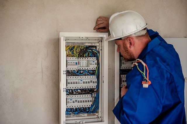An electrician examining a fuse box