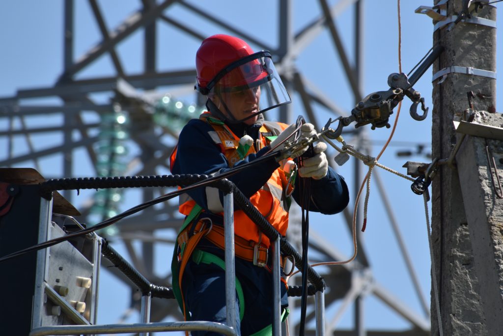 An electrical worker fixes some power lines.