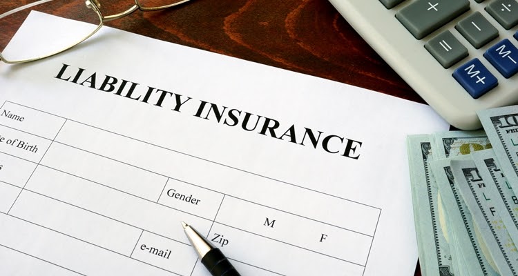 A Close-up of a liability insurance application and a pen laying on a desk.