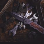 Wrenches and folding knife in shadow