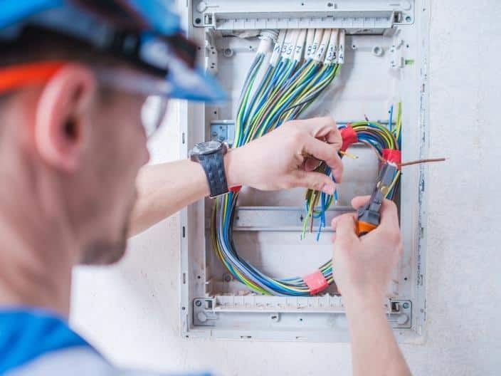 electrician working in electrical box