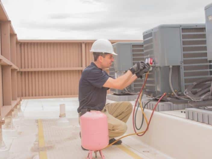 hvac technician working on air conditioner