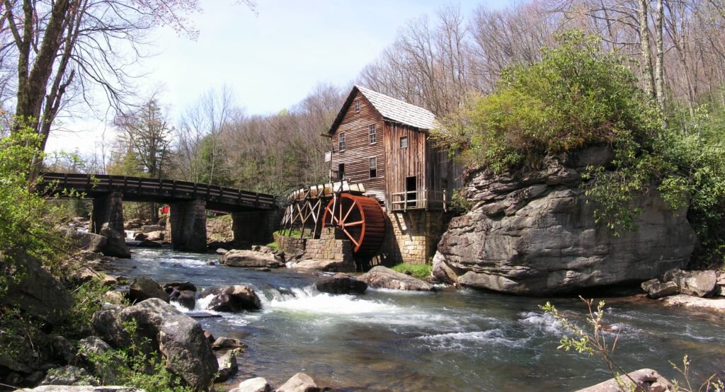Watermill next to bridge and river in West Virginia’s Babcock State park
